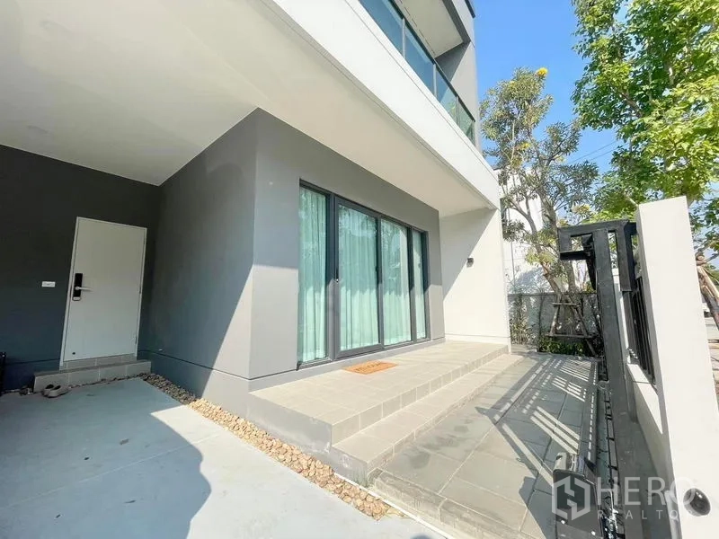 Detached House for rent in Bang Phli, Samut Prakan - Covered front porch with sliding glass doors and a small terrace beside the fence.