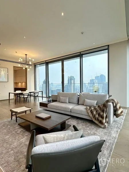 Condominium for rent or sale - Airy living area with sofas, statement lighting and city views toward the kitchen.
