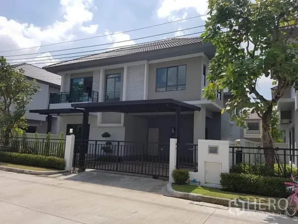 Detached House for rent or sale in Saphan Sung, Bangkok - Modern two-storey detached house with gated carport and landscaped front yard.