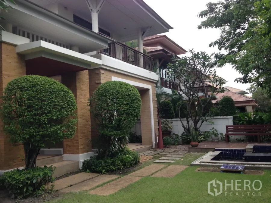 Detached House for rent or sale in Suan Luang, Bangkok - Two-storey detached house with landscaped garden, topiary trees and stone path.