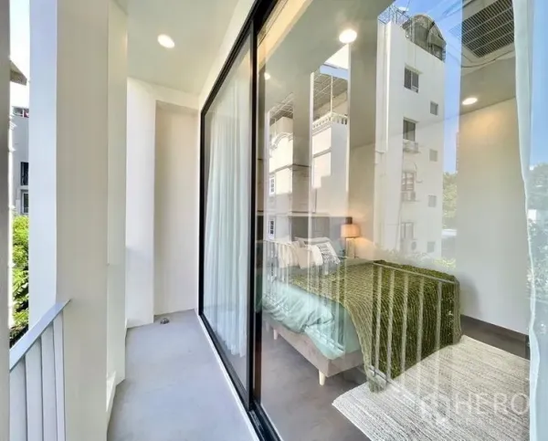 Townhouse for rent - Slim balcony beside a bedroom with floor-to-ceiling sliding glass and city outlook.