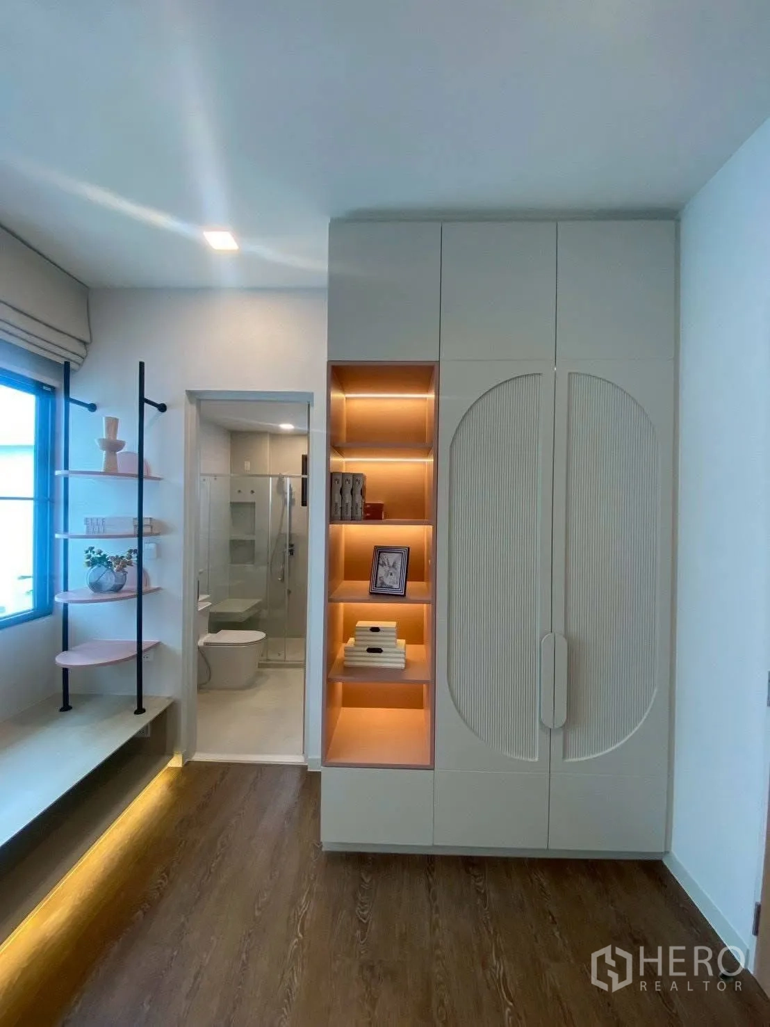 Detached House for rent in Bang Phli, Samut Prakan - Built-in wardrobe with illuminated shelves beside bathroom with glass shower.