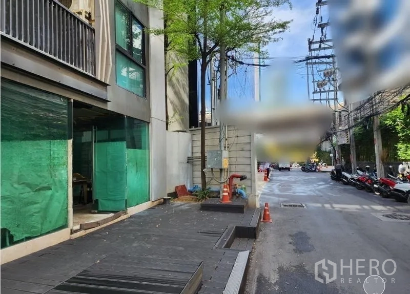 Retail Space for rent - Sidewalk in front of the retail unit showing trees, utilities and direct street access.