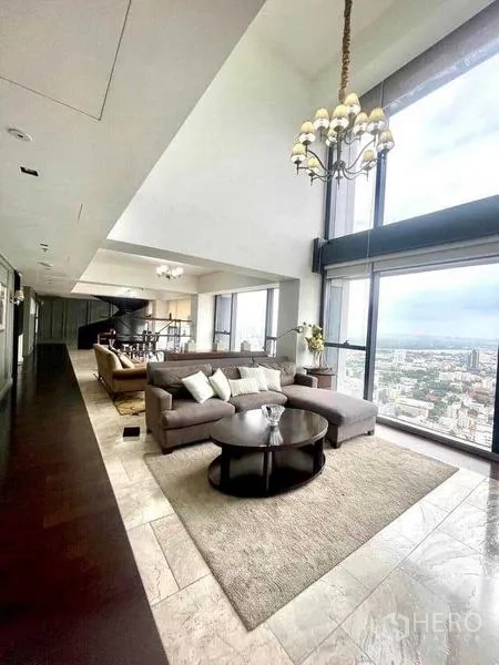 Condominium for rent - Open-plan living and dining with double-height glass and panoramic views.