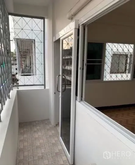 Home Office for rent in Sathon, Bangkok - Narrow balcony with a sliding glass door and safety grilles.