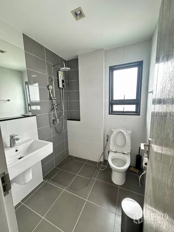 Detached House for rent in Saphan Sung, Bangkok - Bathroom with shower set, toilet and grey wall tiles.