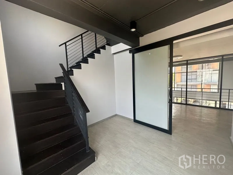 Home Office for rent - Staircase and corridor with black steel stairs and glass divider.