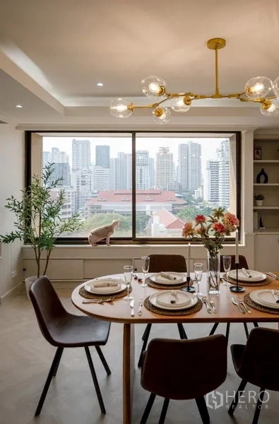 Condominium for sale - Dining table beside a picture window framing city skyline views.