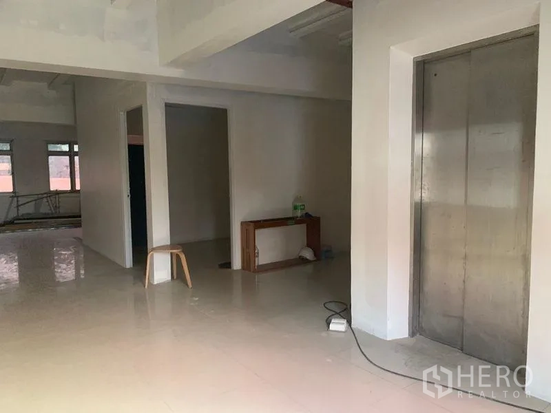 Shophouse for rent in Prawet, Bangkok - Commercial corridor view with elevator door and adjacent rooms.