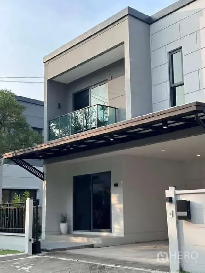 Detached House for sale in Bang Phli, Samut Prakan - Contemporary facade of the detached home with glass railing and driveway.