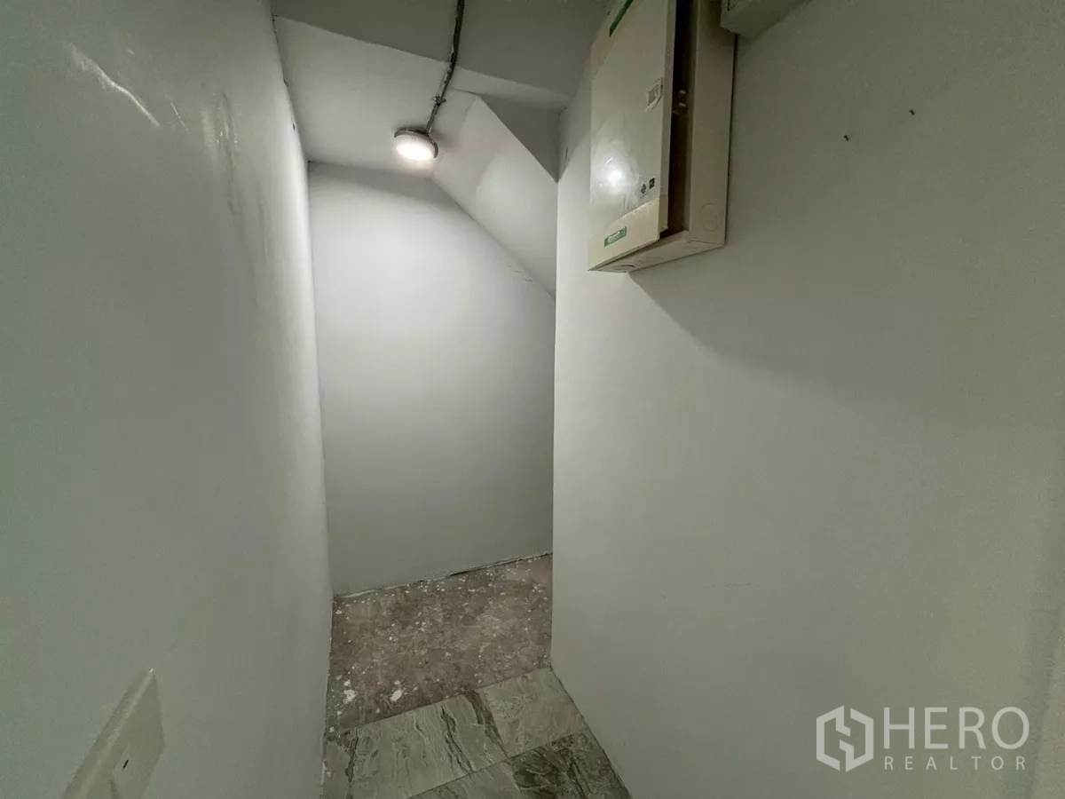 Condominium for sale in Bang Kho Laem, Bangkok - Utility alcove with electrical boxes opening to the living area and large window view.