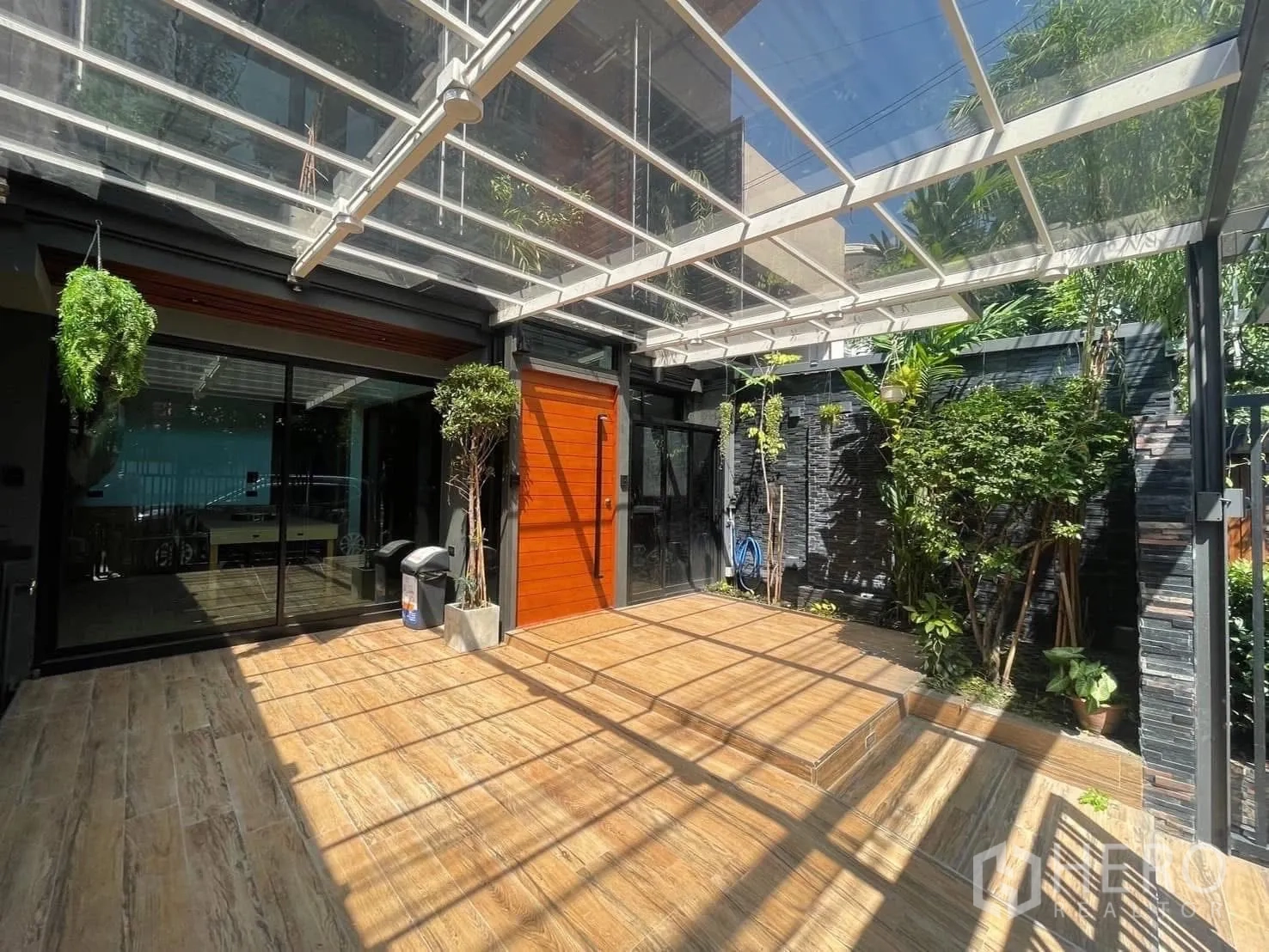 Home Office for rent or sale in Bang Kapi, Bangkok - Covered front terrace with clear roof, wood deck and vertical garden landscaping.