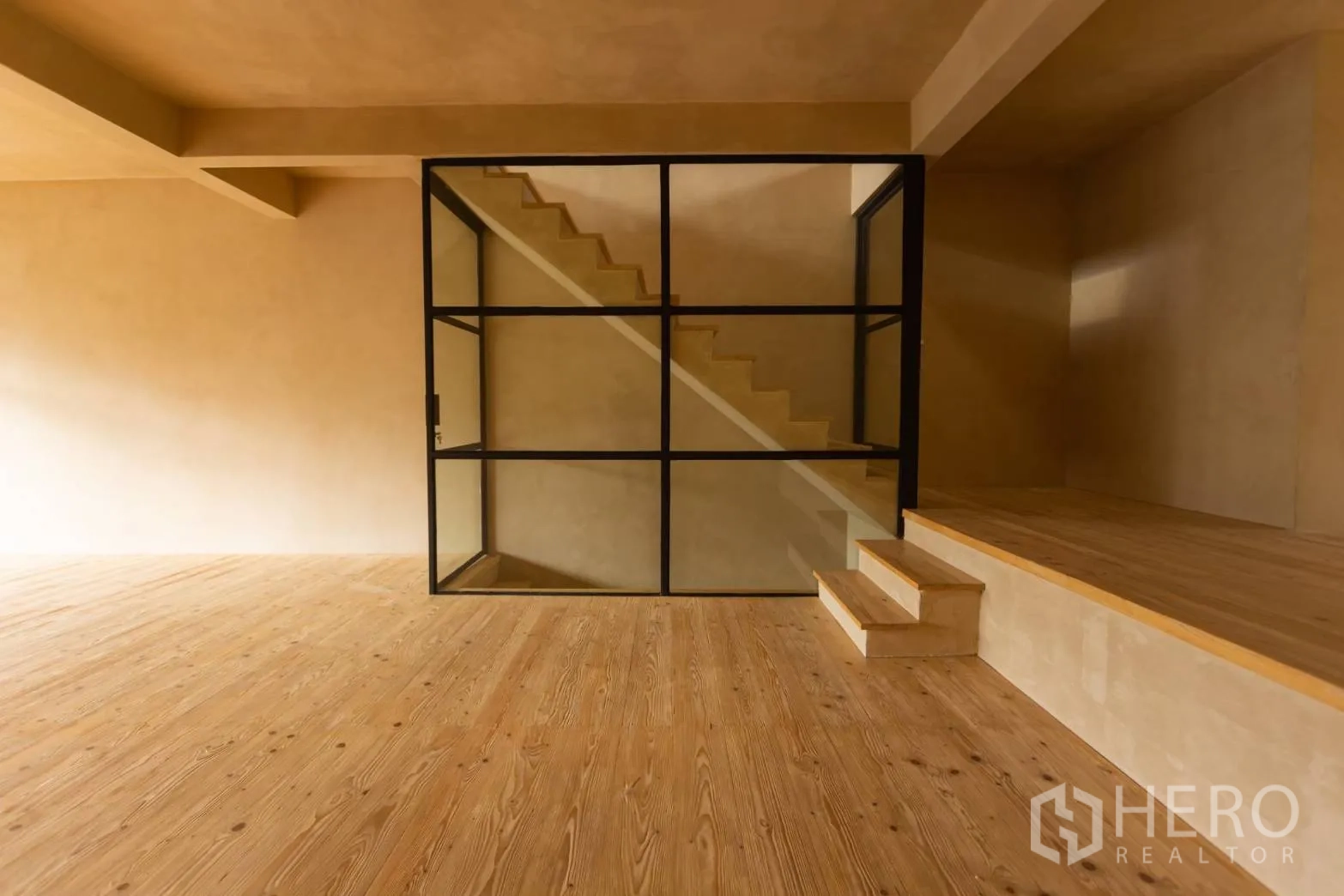 Home Office for rent in Watthana, Bangkok - Detail of steel‑framed glass around the staircase and steps between levels.