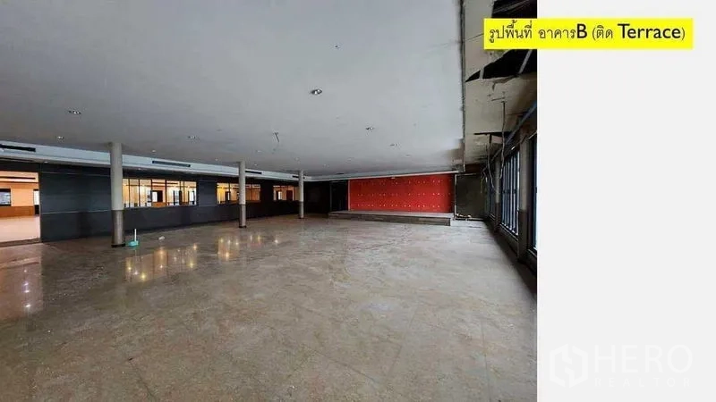 零售空间 出租在Yan Nawa, Bangkok - 开放式商用空间，立柱、舞台背景墙与临露台的落地玻璃。