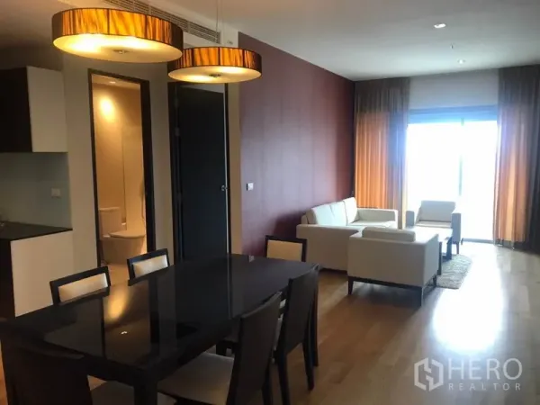 คอนโด ให้เช่าในWatthana, Bangkok - โซนรับประทานอาหารพร้อมโคมไฟแขวนสมัยใหม่ นำสู่ห้องนั่งเล่นสว่างและหน้าต่างบานใหญ่