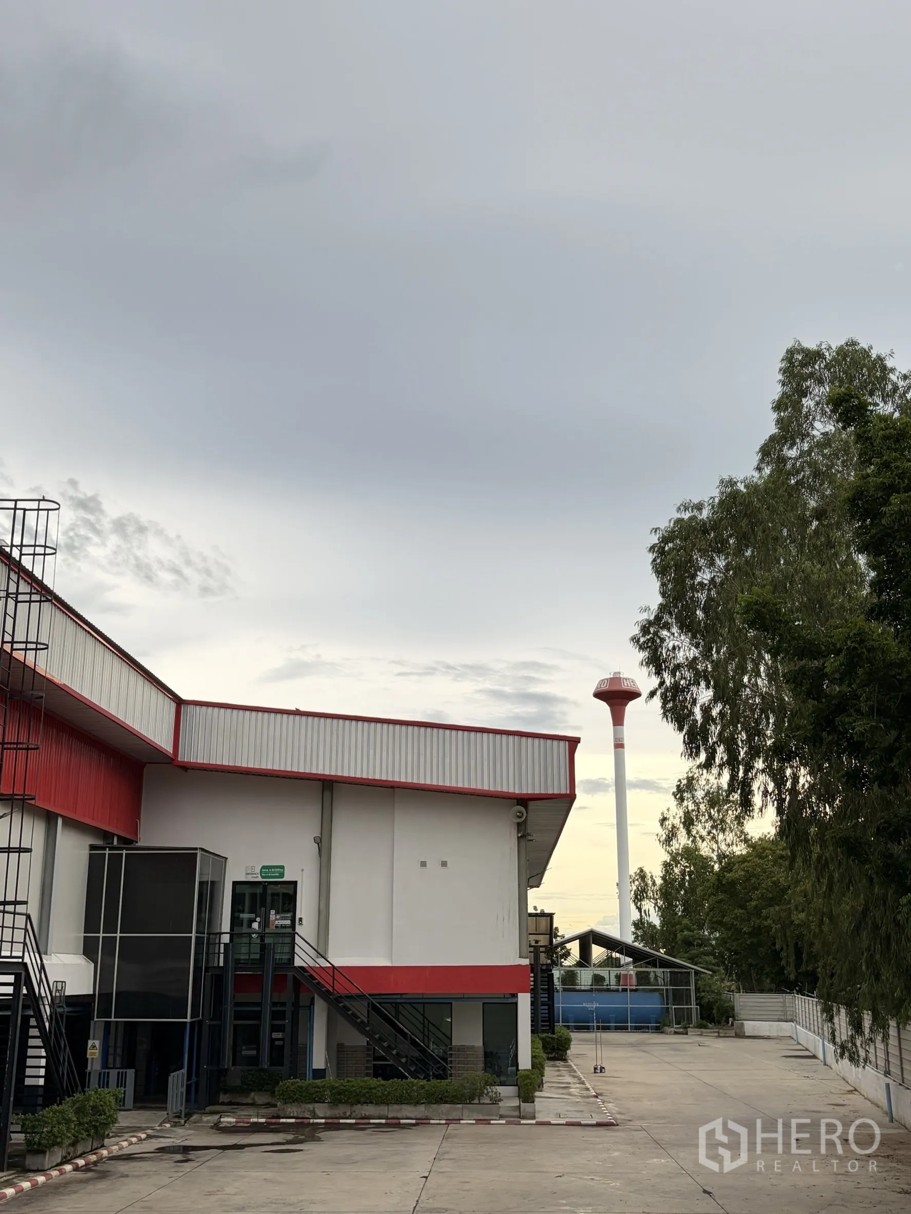 Factory for sale in Mueang Nakhon Pathom, Nakhon Pathom - Main factory building with office block and distant water tower.
