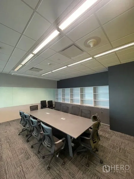 Office Space for rent in Dusit, Bangkok - Fitted conference room with long table, ergonomic chairs, built-in shelving and ceiling lights.
