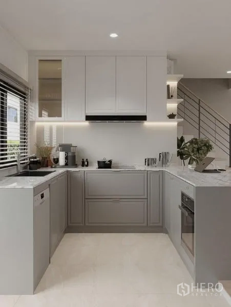 Detached House for rent in Bang Phli, Samut Prakan - U-shaped kitchen with white upper cabinets, marble countertops and soft under-cabinet lighting.