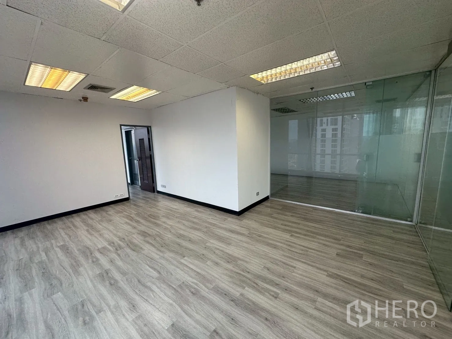 Office Space for rent - Private manager’s room next to a glass wall and door within the office suite.