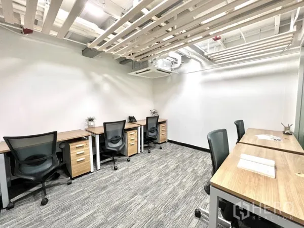 Office Space for rent in Khlong Toei, Bangkok - Small team office featuring multiple workstations, white walls, slatted ceiling, and grey carpet.