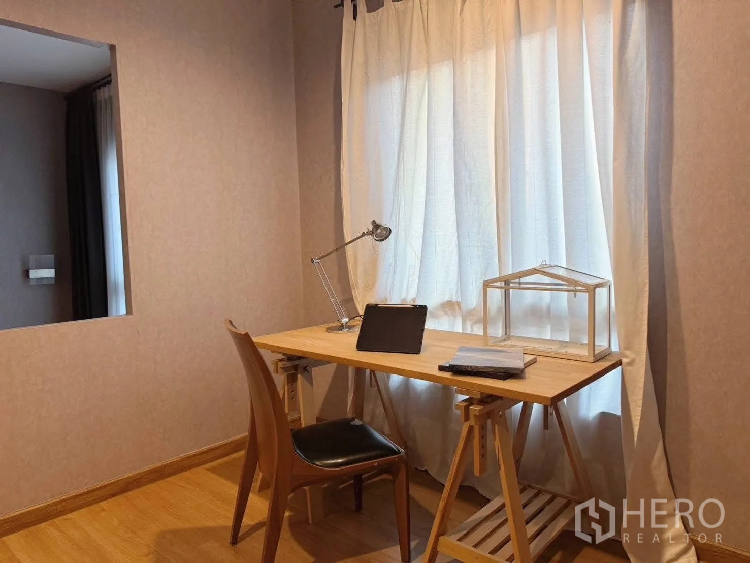 Detached House for rent or sale in Suan Luang, Bangkok - Work area with wooden desk, task lamp and tablet by window.