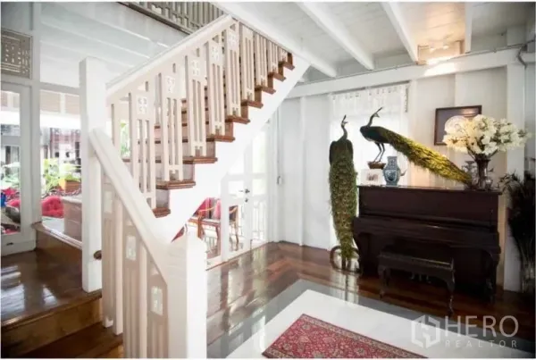 Detached House for rent in Bang Rak, Bangkok - Bright entry hall with a white staircase, polished wooden floors and a piano.