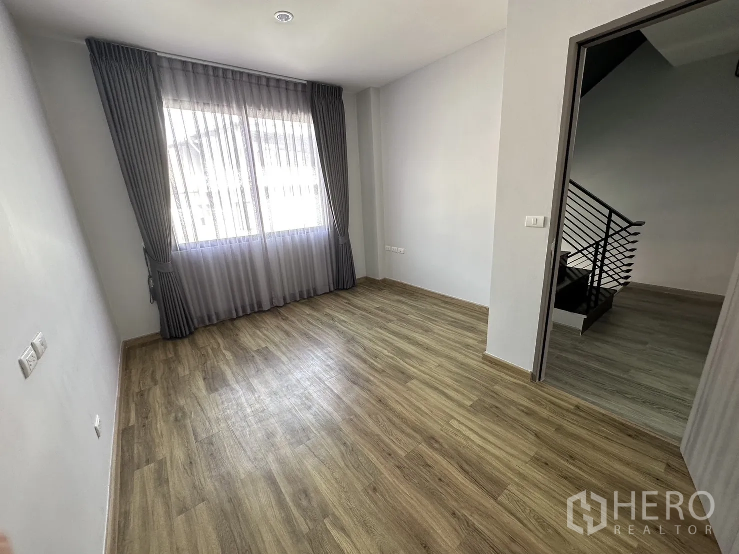 带办公室的家 出租或出售在Suan Luang, Bangkok - 卧室设大窗、灰色窗帘与温暖木纹地板。