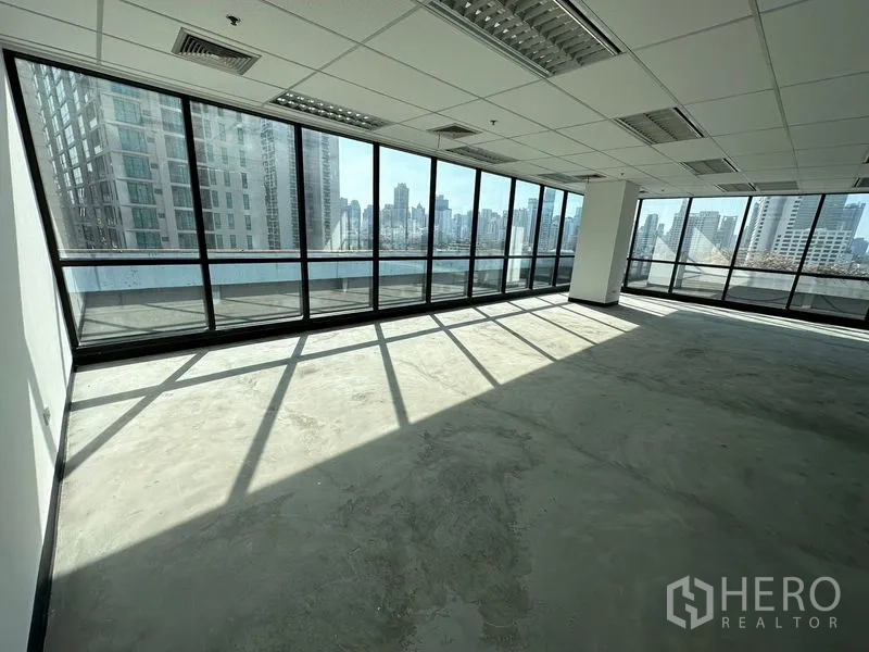 Office Space for rent in Watthana, Bangkok - Bright corner office with floor-to-ceiling windows and Bangkok skyline views.