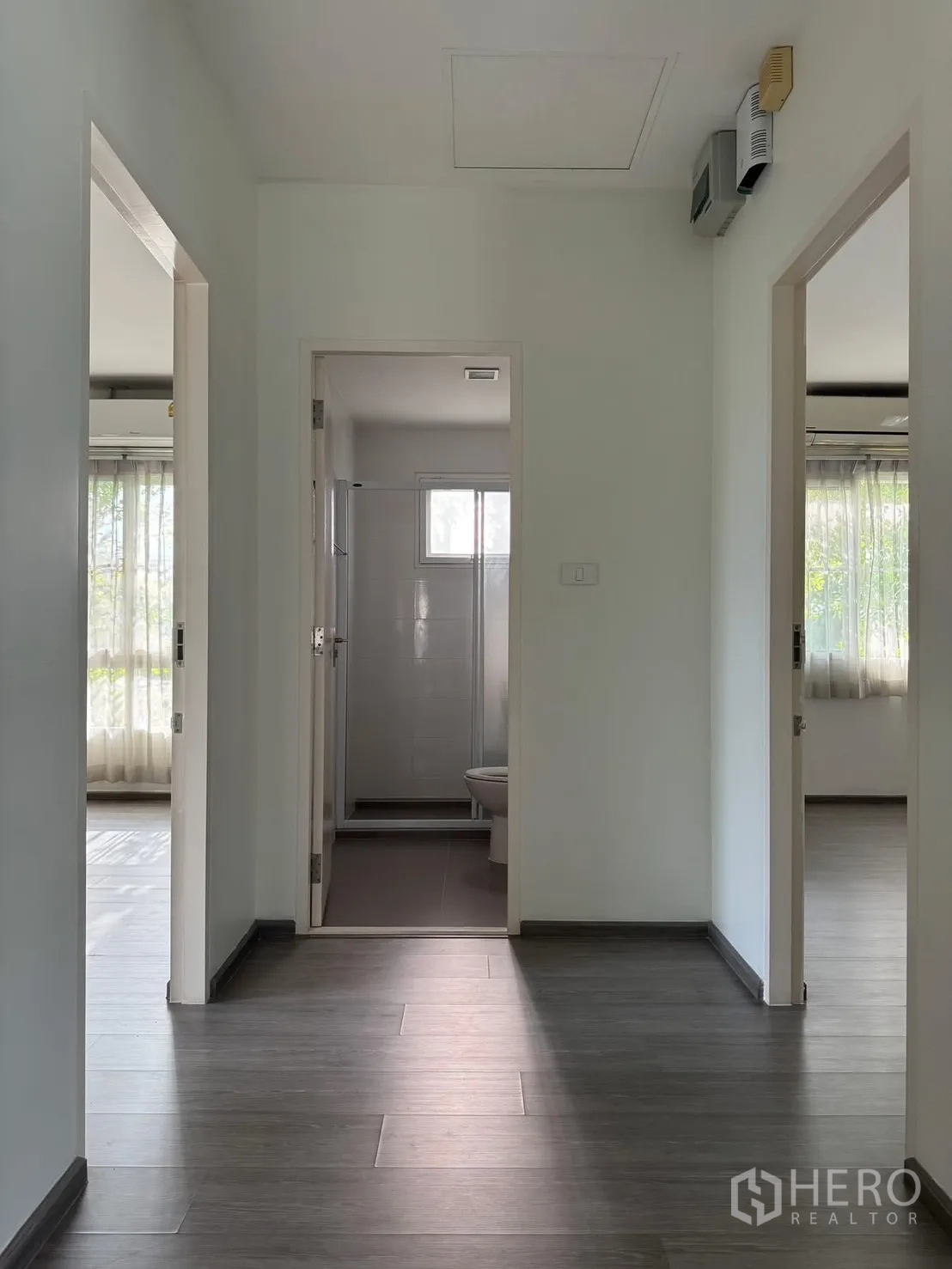 Detached House for rent in Bang Phli, Samut Prakan - Upstairs landing with wood-look floor leading to bedrooms and bathroom.