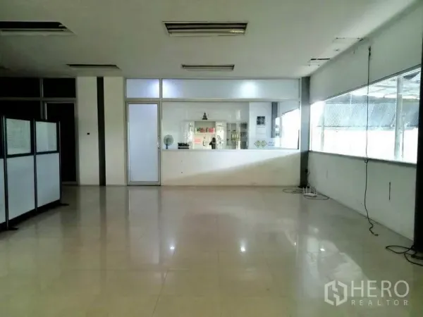 Factory for rent in Bang Phli, Samut Prakan - Bright office or reception area with large windows, glass door and polished tile flooring.