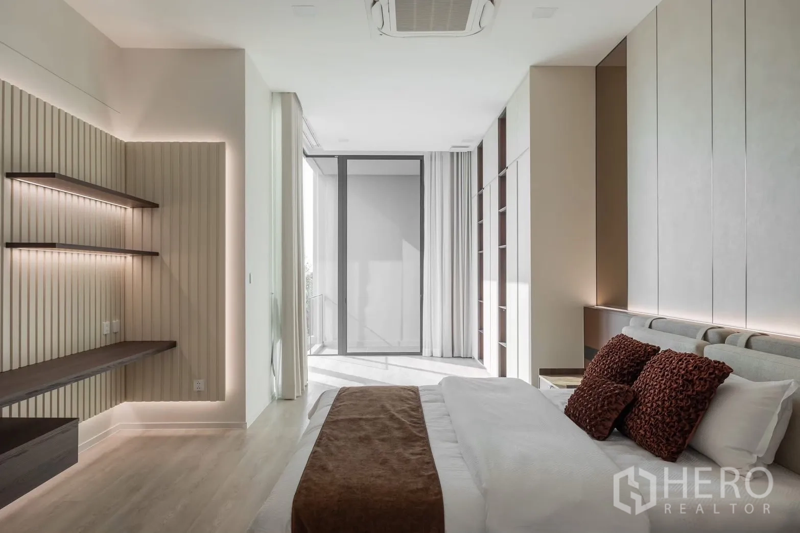 Detached House for rent in Saphan Sung, Bangkok - Master suite angle showing floating desk, shelves, and sliding door to terrace.