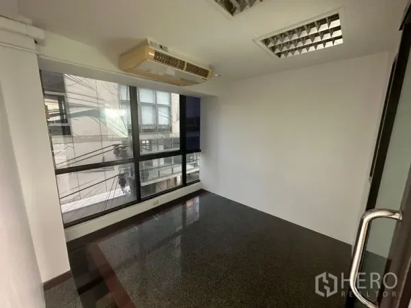 Office Space for rent in Sathon, Bangkok - Small meeting room with a window, built-in AC and dark granite flooring.