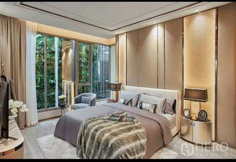 Condominium for sale in Bang Kho Laem, Bangkok - Warmly lit bedroom with floor‑to‑ceiling windows, garden view, and modern bedside lamps.