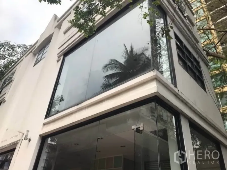 พื้นที่ขายปลีก ให้เช่าในWatthana, Bangkok - อาคารมุมสมัยใหม่พร้อมกระจกเต็มบาน สะท้อนต้นไม้ด้านนอก