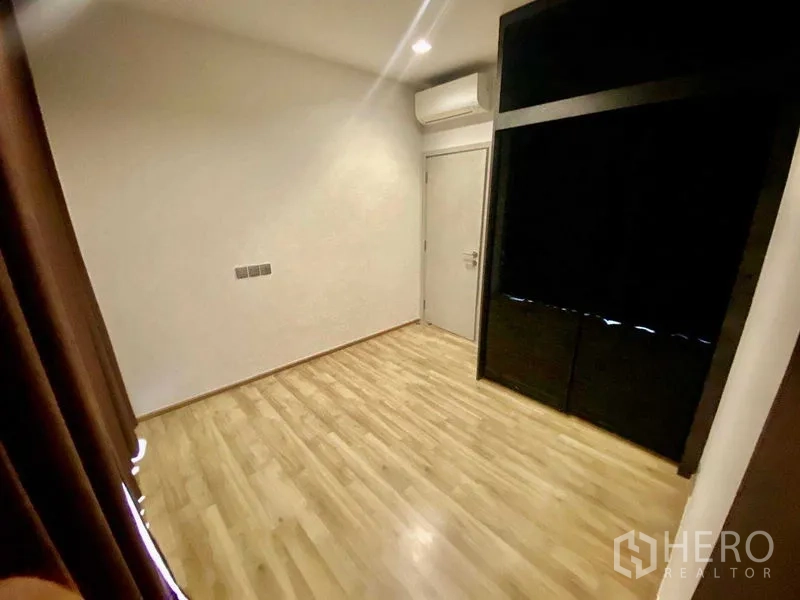 คอนโด ให้เช่าหรือขาย - ห้องนอนรองพื้นไม้ มีเครื่องปรับอากาศและตู้บิวท์อิน