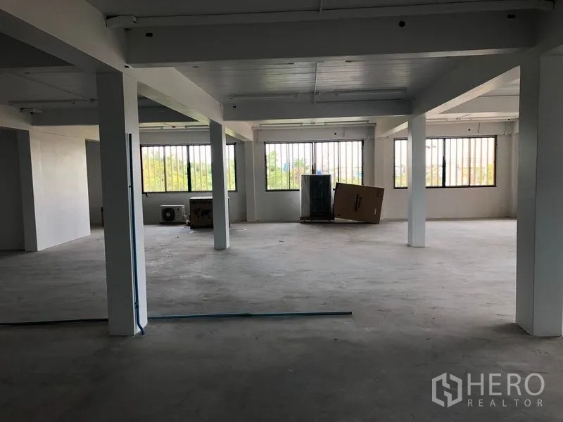 Office Space for rent in Lat Krabang, Bangkok - Spacious unfinished office area with grid windows bringing in natural light.