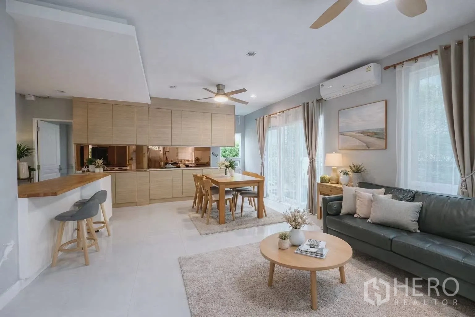 Detached House for rent or sale in Bang Phli, Samut Prakan - Spacious living–dining room with sofa, dining table, breakfast bar, and big windows.