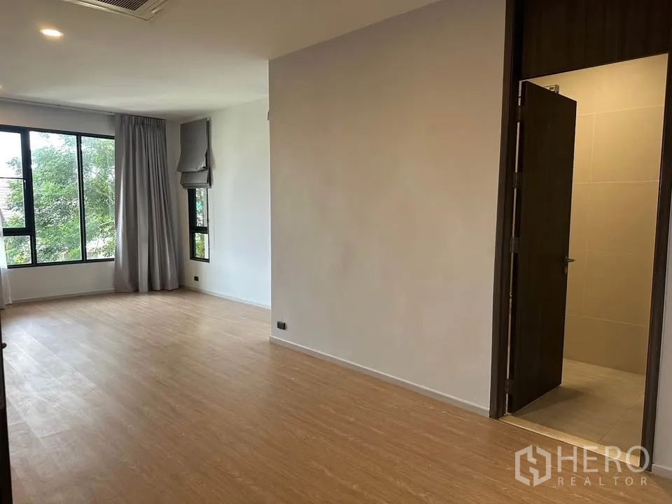 Detached House for sale in Watthana, Bangkok - Bedroom view showing the private bathroom entrance and windows.