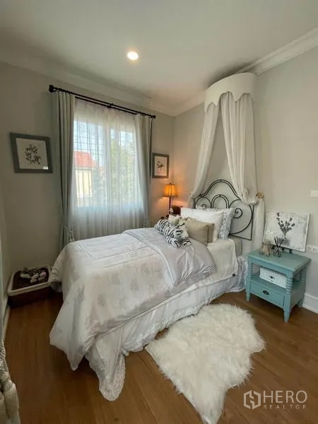 Detached House for rent or sale in Pathum Thani - Secondary bedroom with canopy bed, soft rug and natural light.
