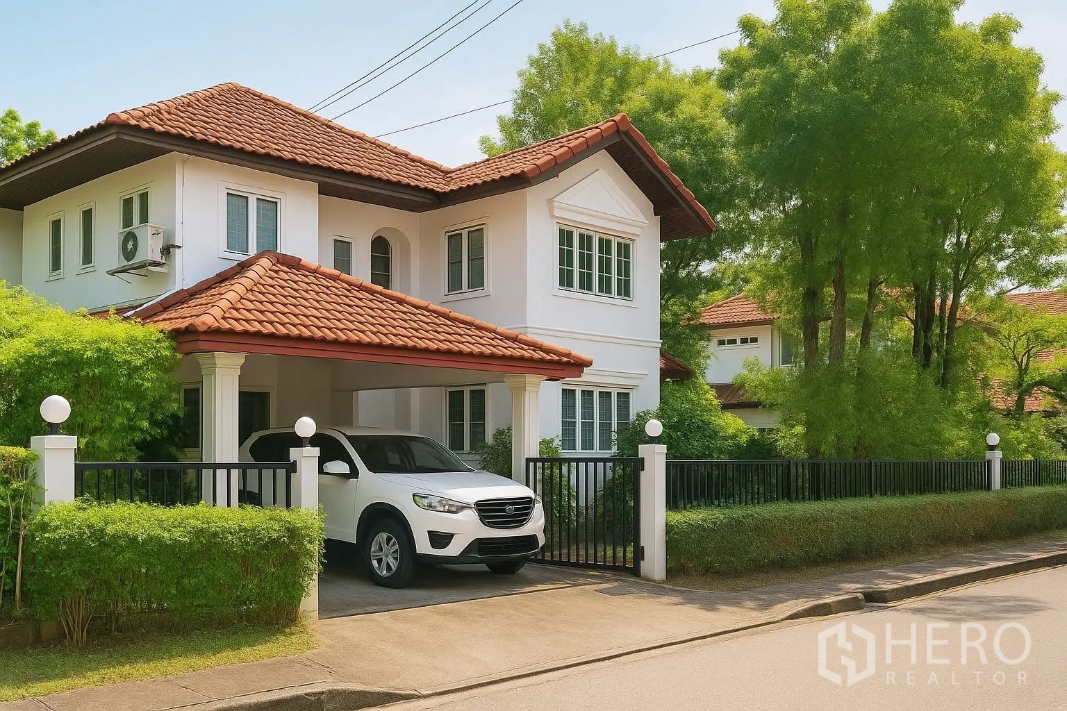 Detached House for rent in Saphan Sung, Bangkok - Front exterior with covered carport, gate and mature greenery.
