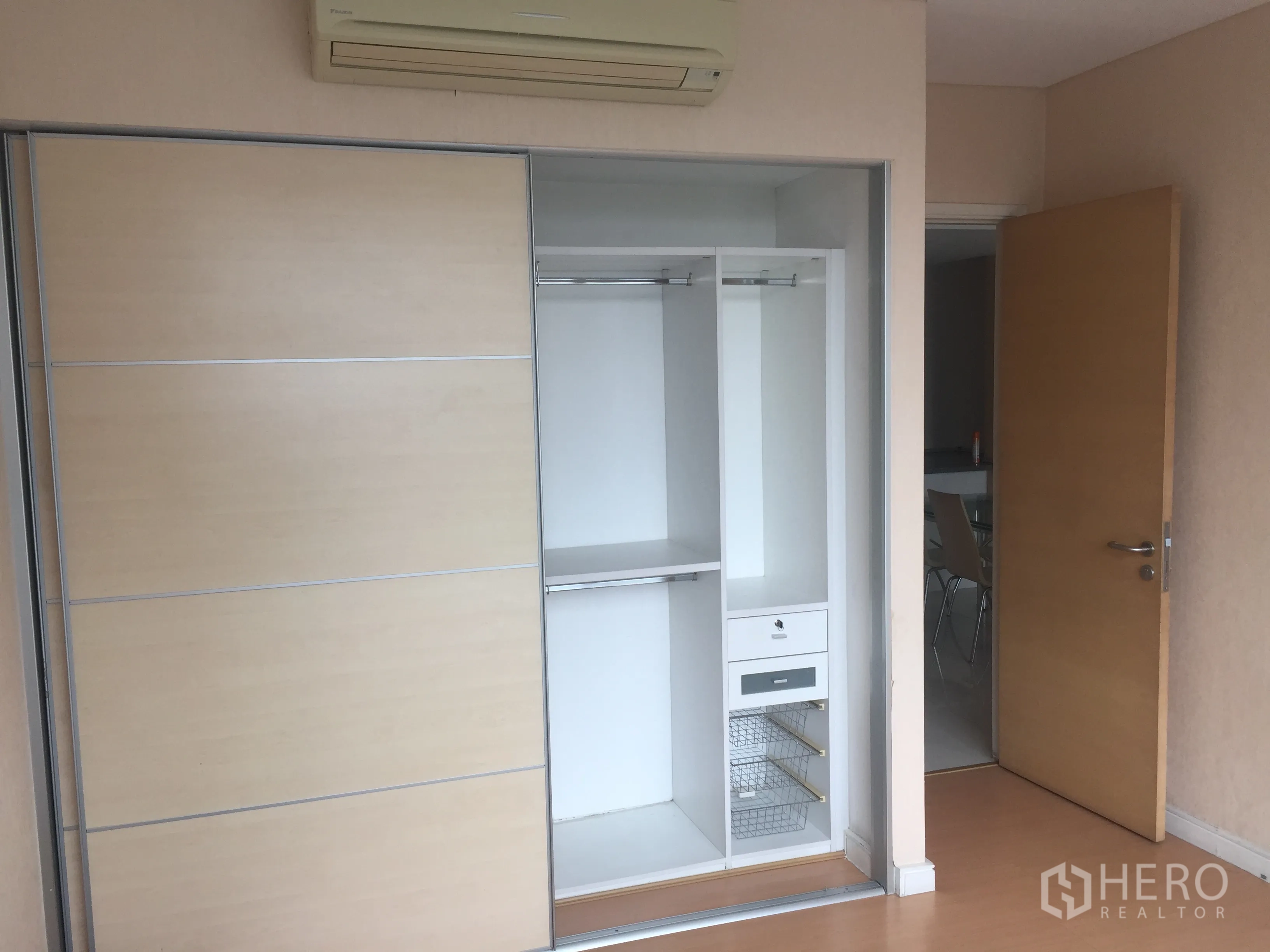 Condominium for rent or sale in Watthana, Bangkok - Bedroom featuring a built-in sliding wardrobe with organized storage in a modern Bangkok condo.