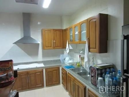 Home Office for rent or sale in Wang Thonglang, Bangkok - Second kitchen with wooden cabinets, dual sinks and range hood.