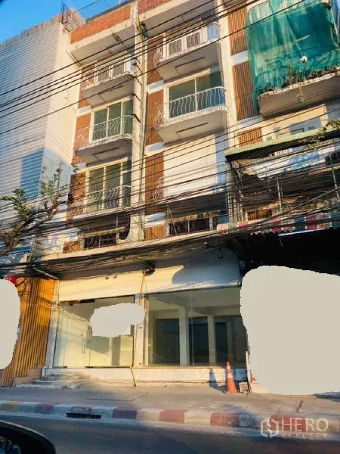 店屋 出租在Khlong Toei, Bangkok - 四层临街商铺外立面，整面玻璃橱窗与小阳台。