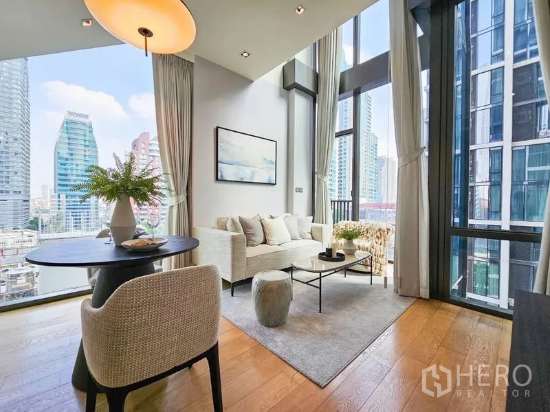 Condominium for rent - Living room with high ceilings, round dining table, and skyline view.