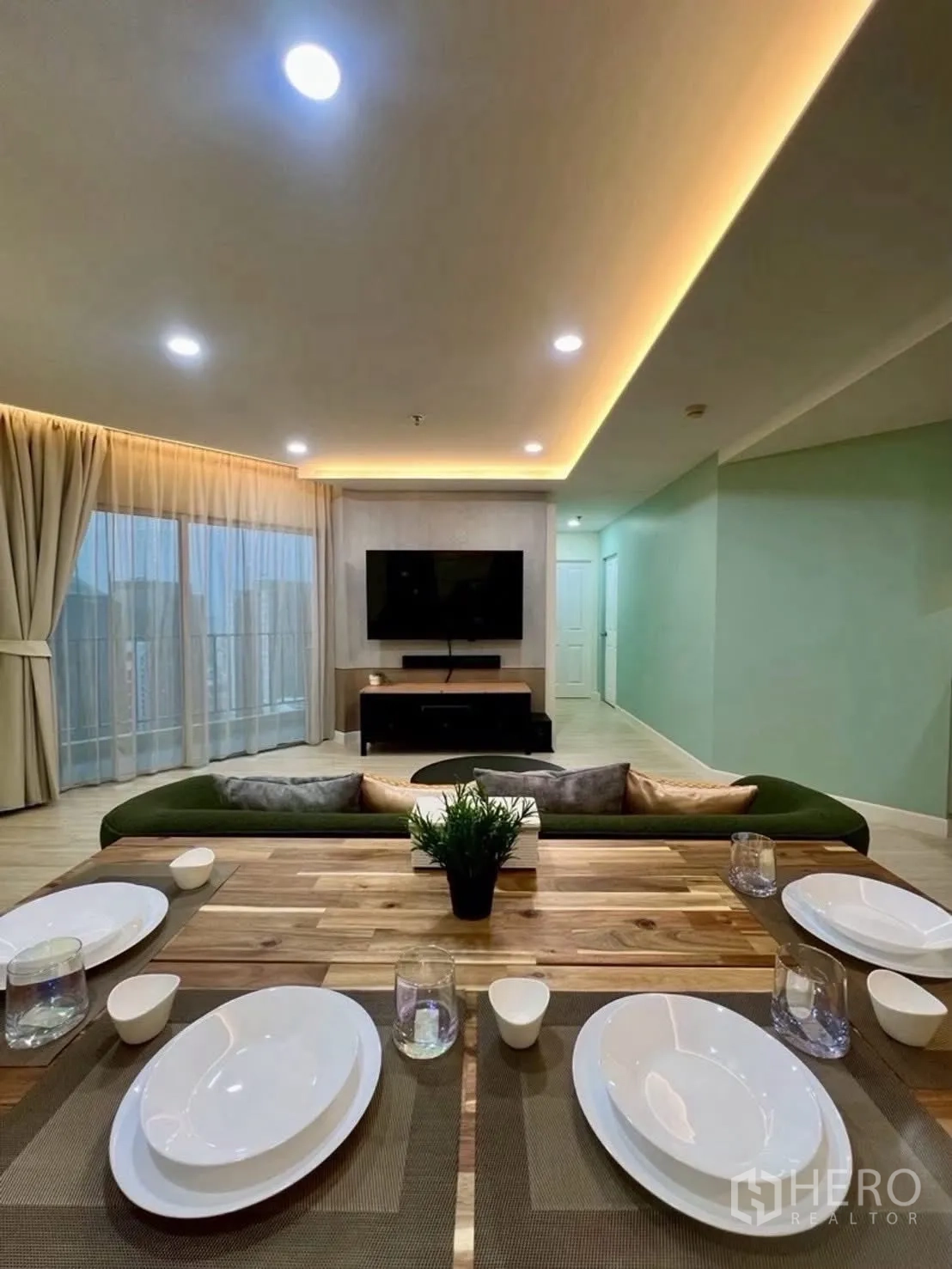 Condominium for rent in Huai Khwang, Bangkok - Open-plan living and dining with soft ceiling lighting.