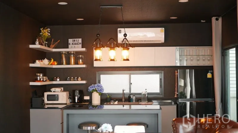Detached House for rent or sale in Bang Bo, Samut Prakan - Open-plan Western kitchen with island, pendant lights and built-in cabinets.