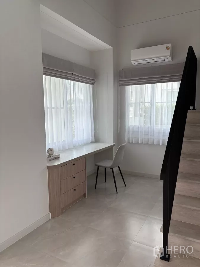 Detached House for rent or sale in Bang Phli, Samut Prakan - Study nook under the stairs with built-in desk and air conditioner.