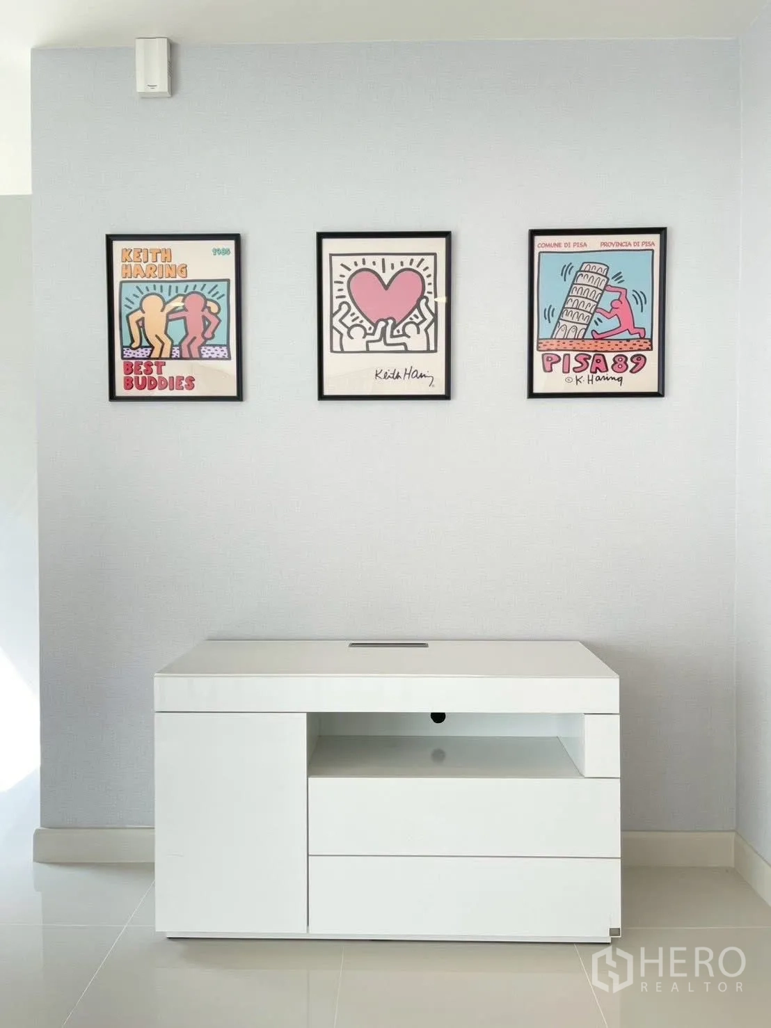 Detached House for rent in Bang Phli, Samut Prakan - Wall with three framed artworks above a white storage cabinet.