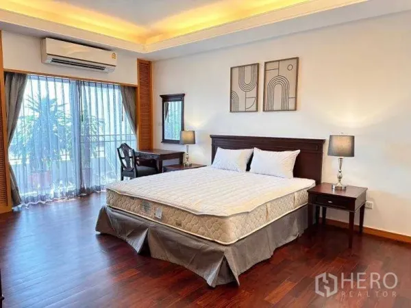 Apartment for rent - Spacious master bedroom with wood floors, balcony access and a work desk.