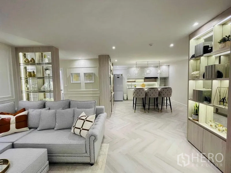 Condominium for sale in Yan Nawa, Bangkok - Open kitchen with island breakfast bar, pendant lights, and ample cabinetry.